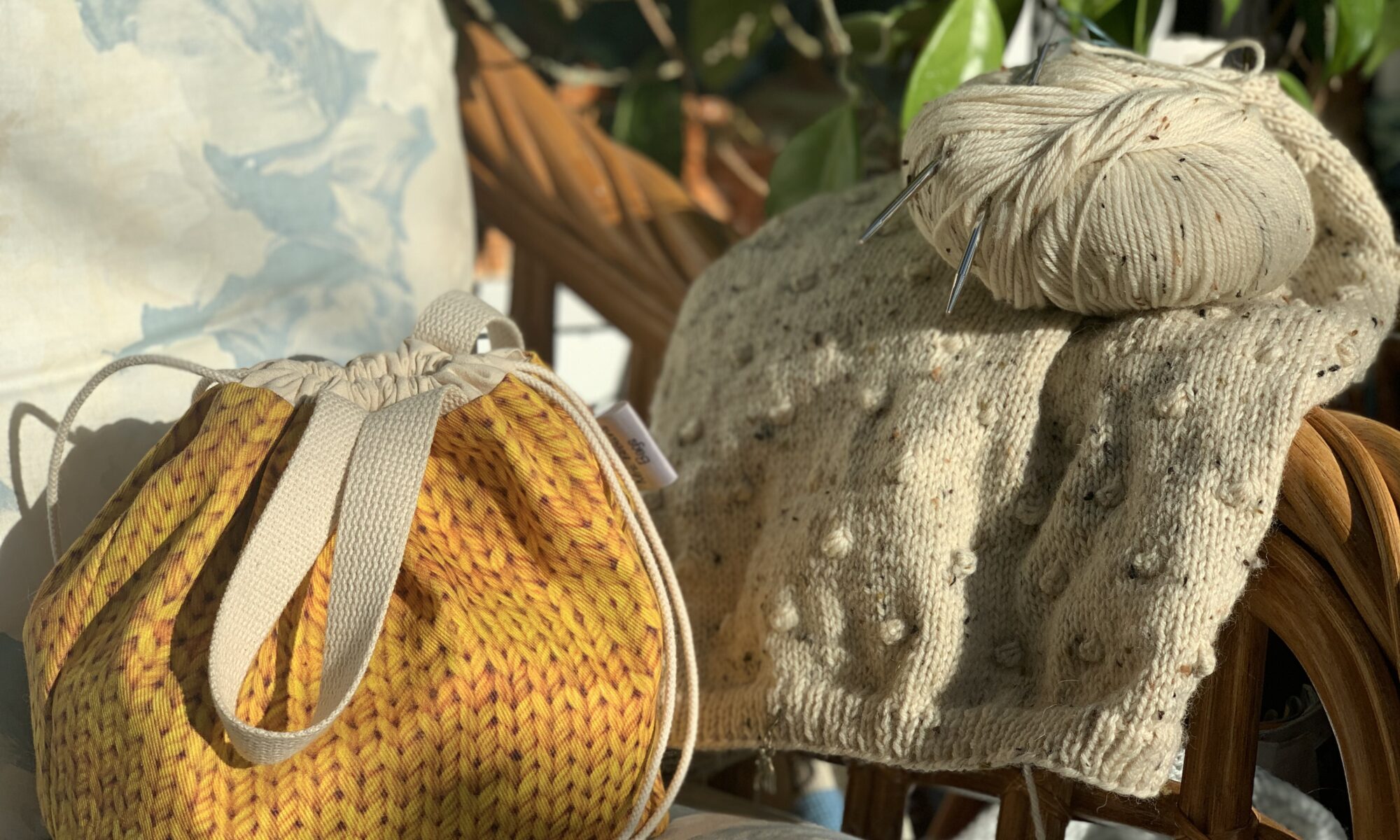Image of a knitting bag and work of knitting on a chair